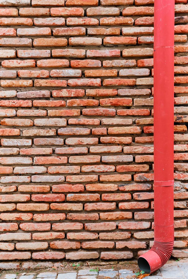 Brick facades of old houses, renovation of houses in old cities. The idea of a background or screensaver from red old brick, wallpaper design